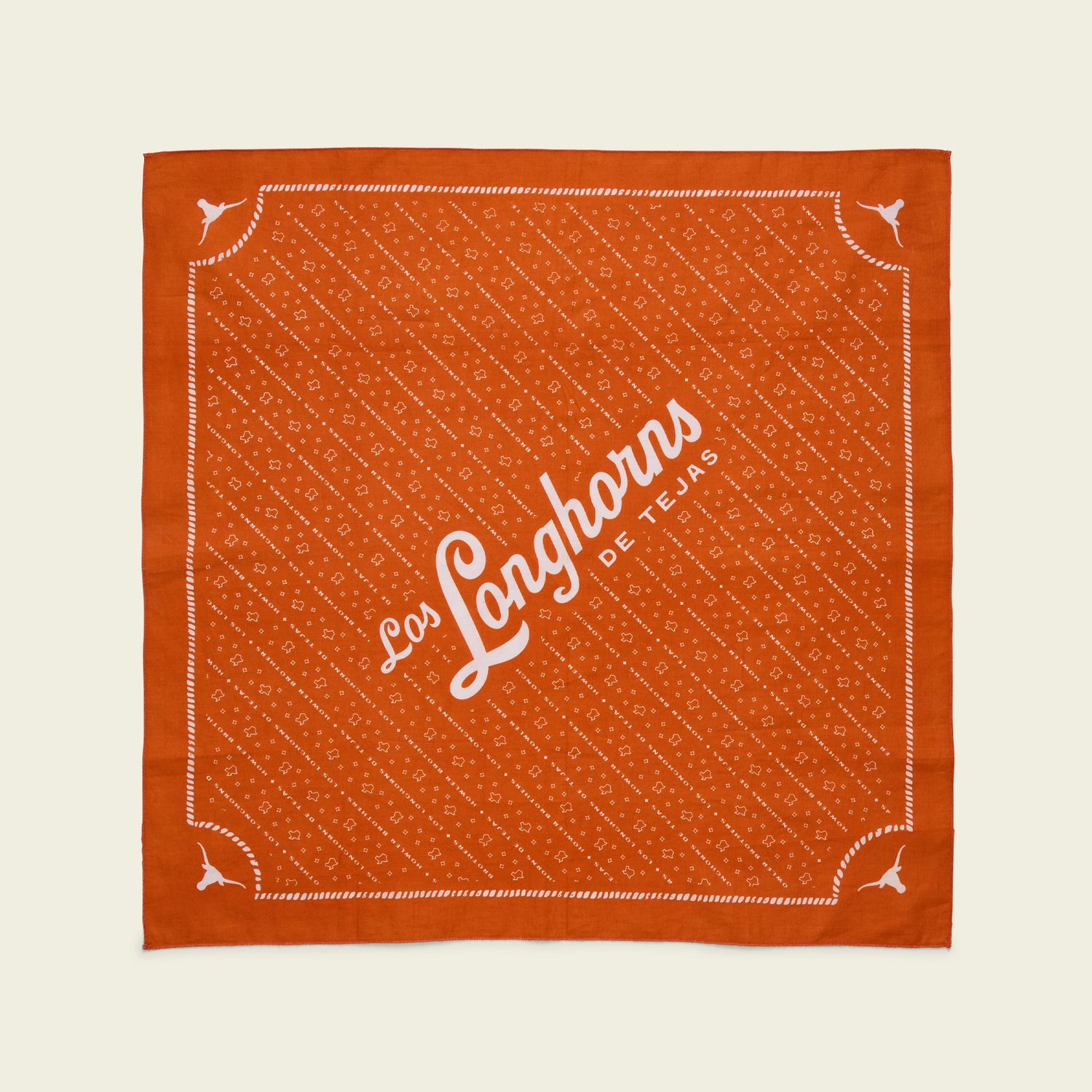 Burnt orange square bandana with white decorative patterns, corners featuring small longhorn symbols, and “Los Longhorns de Tejas” written diagonally—an ideal game day accessory for University of Texas Longhorns fans.