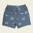 Blue boardshorts with a white abstract wave pattern, elastic waistband, 7” inseam, side pocket, and a back pocket with a Hawker label patch. The shorts are laid flat on a light background.