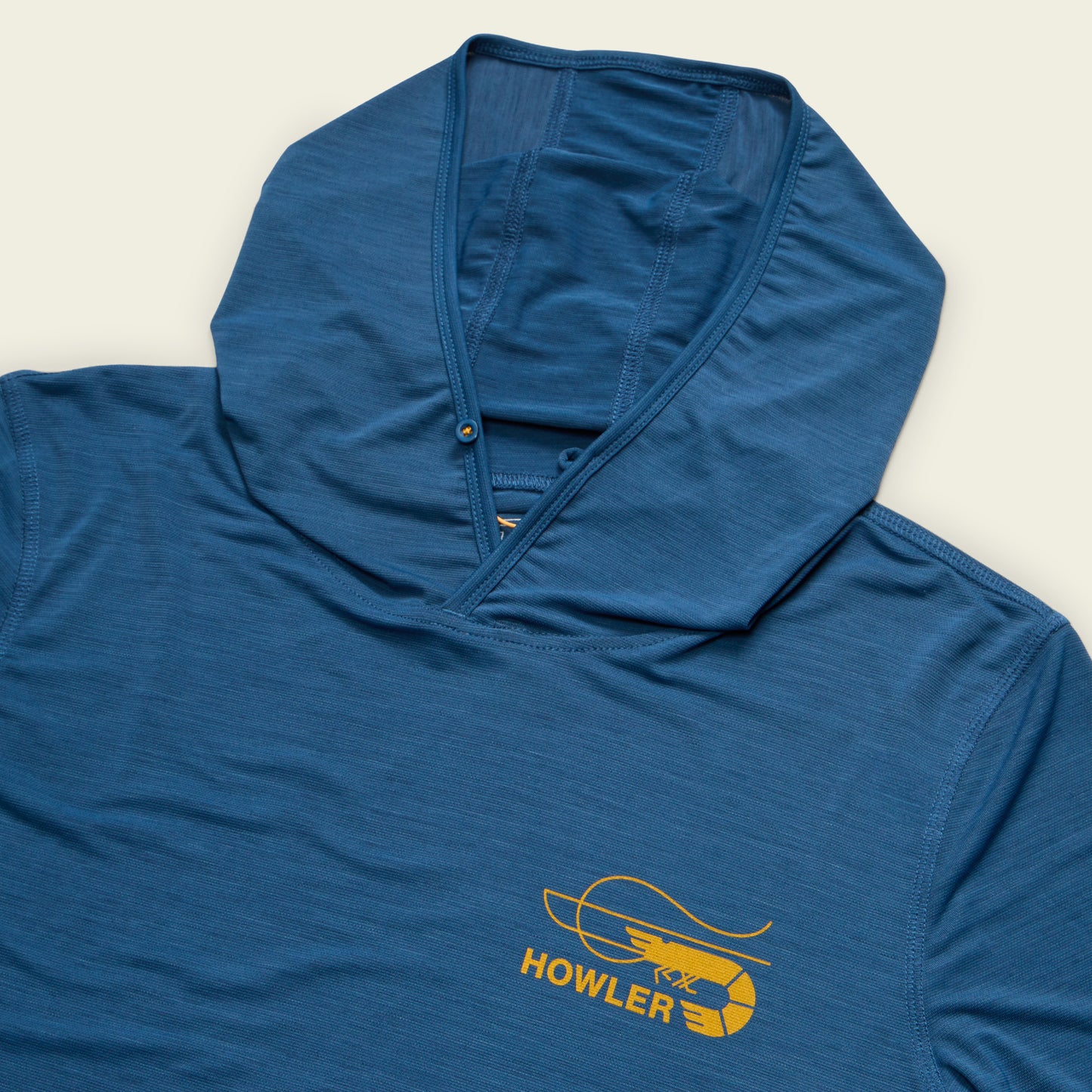 A blue hooded tech shirt with a yellow graphic of a shrimp and the word HOWLER on the chest, featuring UPF 50+ sun protection, displayed on a light background. - View 3