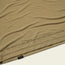 Close-up of a tan lightweight UPF shirt with HB TECH T // UPF 50+ SUN PROTECTION /// HOWLER printed near the hem and a small black and yellow UPF 50 tag on the seam. Made from a soft polyester spandex blend.